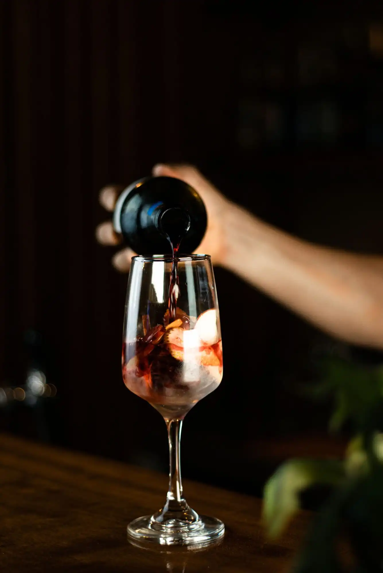 A glass of natural wine being poured